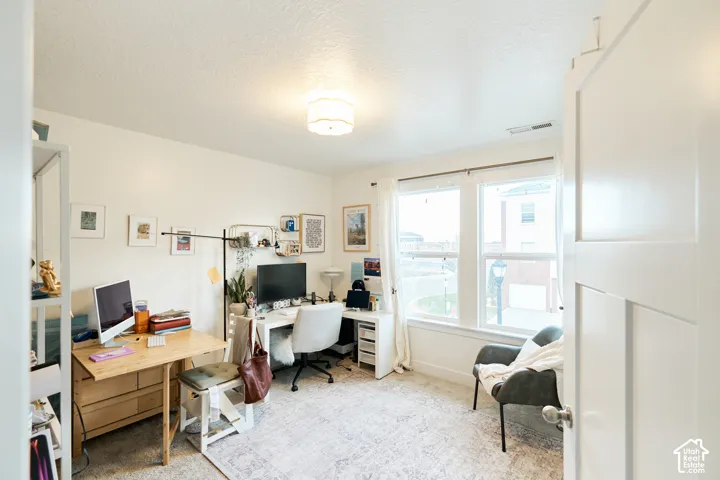 Room featuring dual-pane windows, neutral wall coloring, and a flush-mount ceiling light fixture