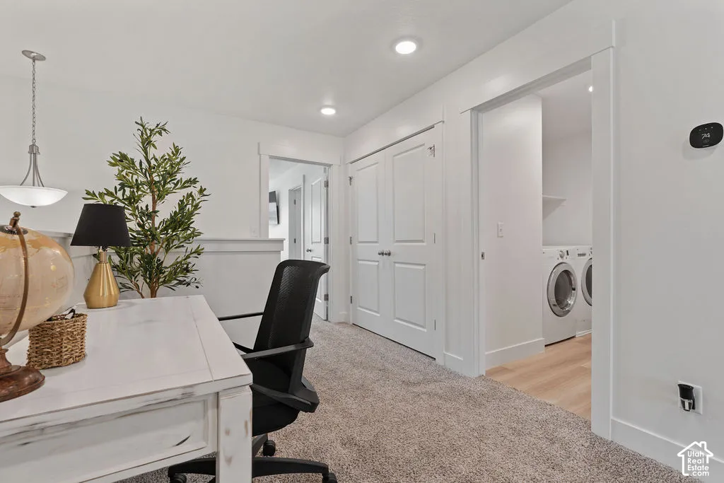 Neutral-toned carpeting, recessed ceiling lighting, double-panel interior doors, and dedicated laundry area with wood-finish flooring