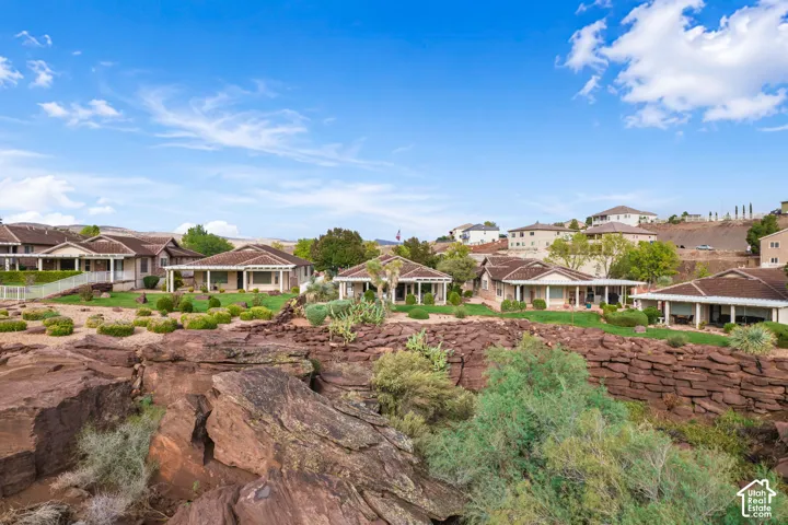 Natural rock formations featuring native desert landscaping, covered patios, and structured stone retaining walls