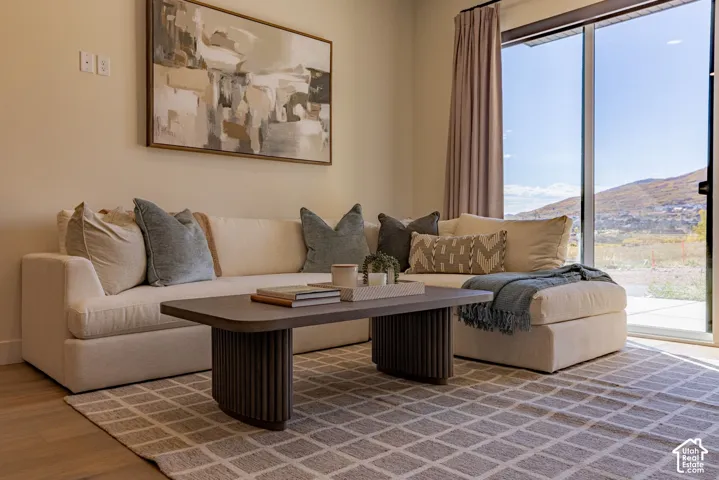 Wood-finish flooring, full-height sliding glass door, and expansive mountain scenery