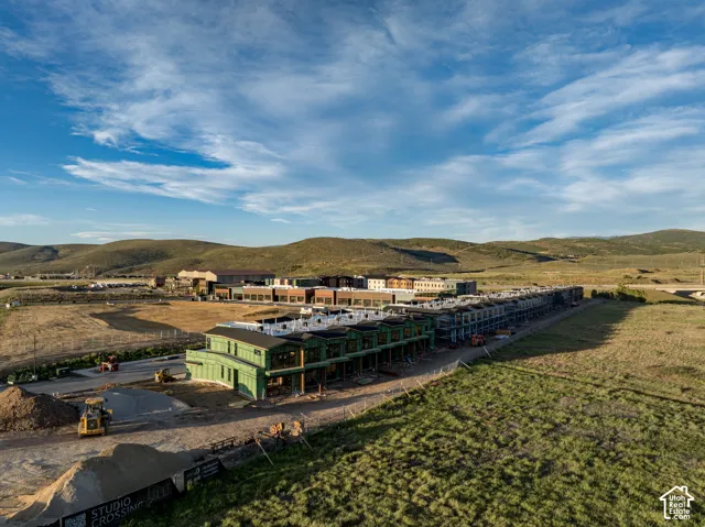 Aerial perspective of a multi-unit residential development featuring wood-framed construction and mountain scenery