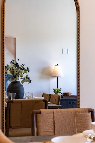 Full-length arched mirror featuring a textured, metallic-finish beaded frame