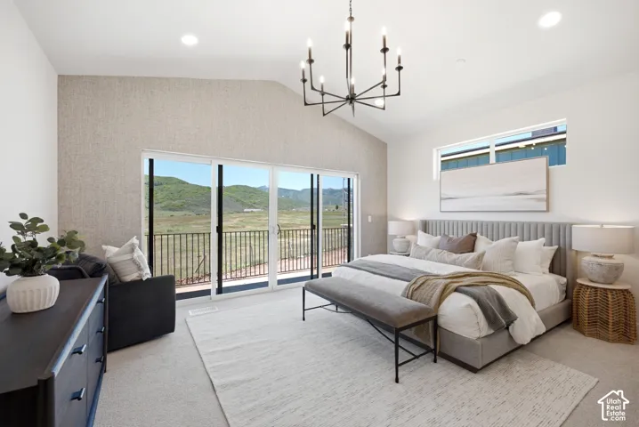 Vaulted ceiling with an industrial-style chandelier, textured accent wall, sliding glass door with access to a balcony featuring metal railings, and clerestory window