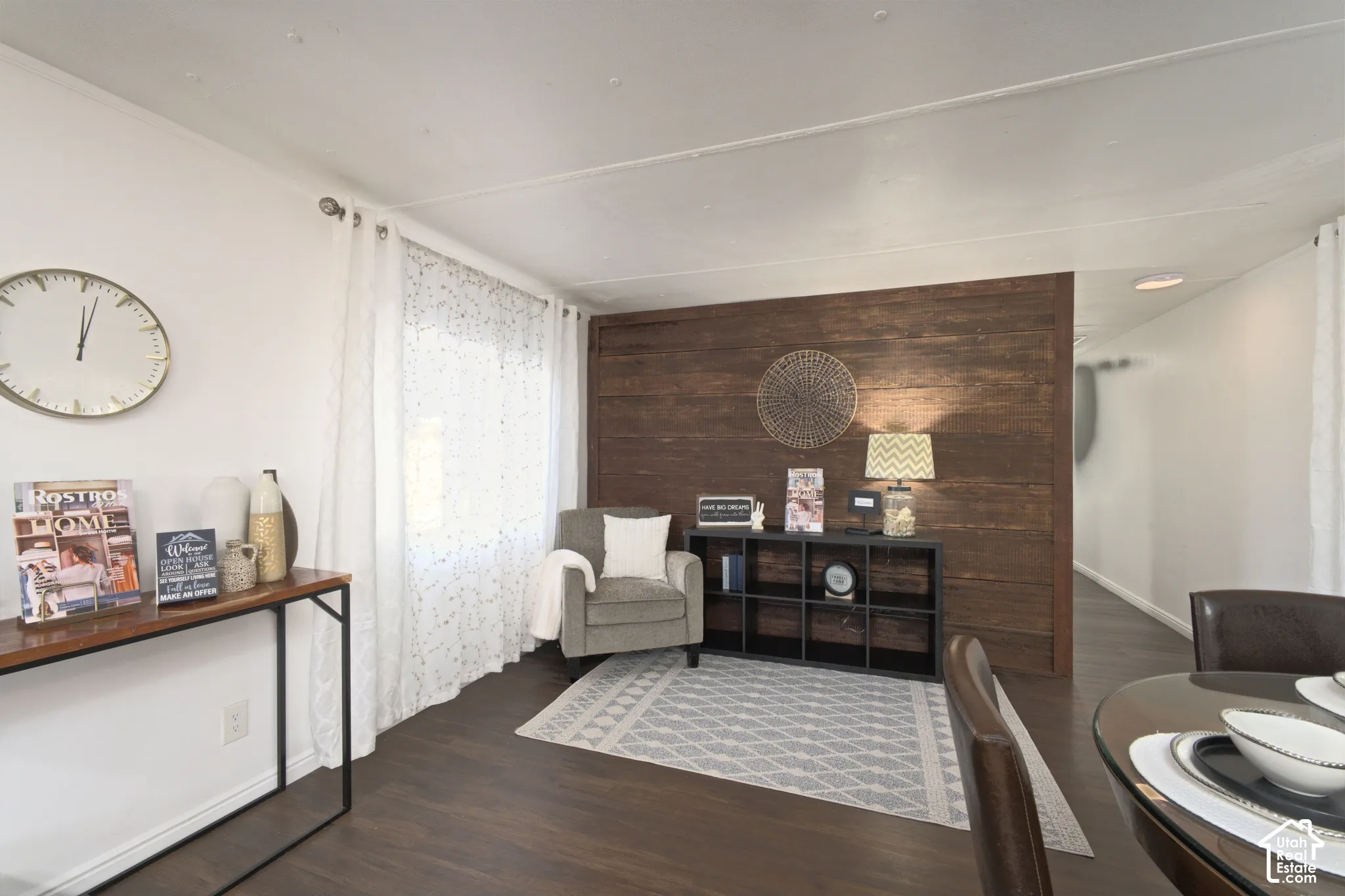 Living area featuring a horizontal wood-plank accent wall and dark wood-finish flooring