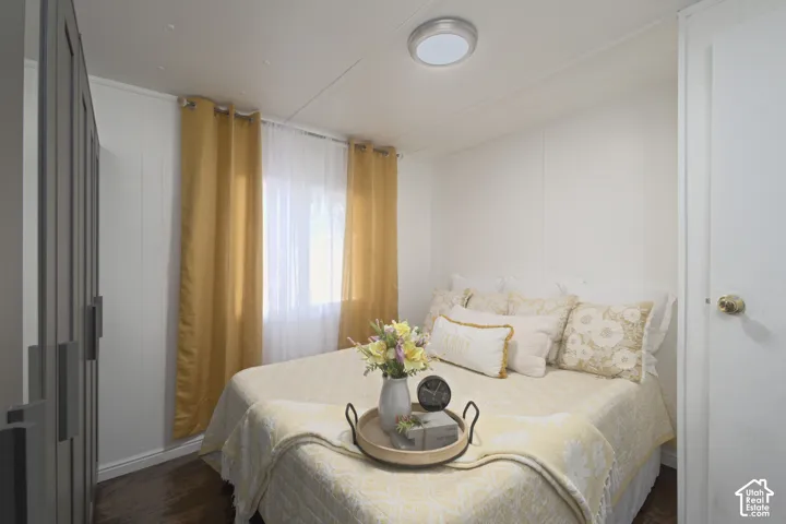 Built-in storage cabinetry, wood-finish flooring, and a flush-mount overhead light fixture