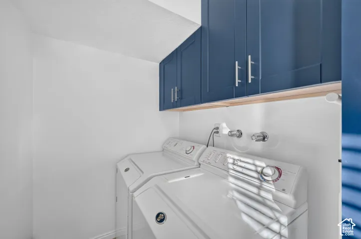Custom navy blue cabinetry with brushed nickel pulls, mounted above white wall surfaces