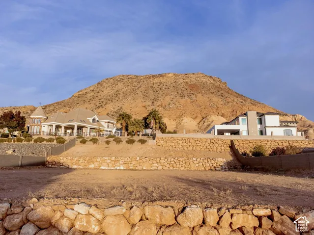 Multi-level terraced property featuring natural stone retaining walls and prominent mountain backdrop
