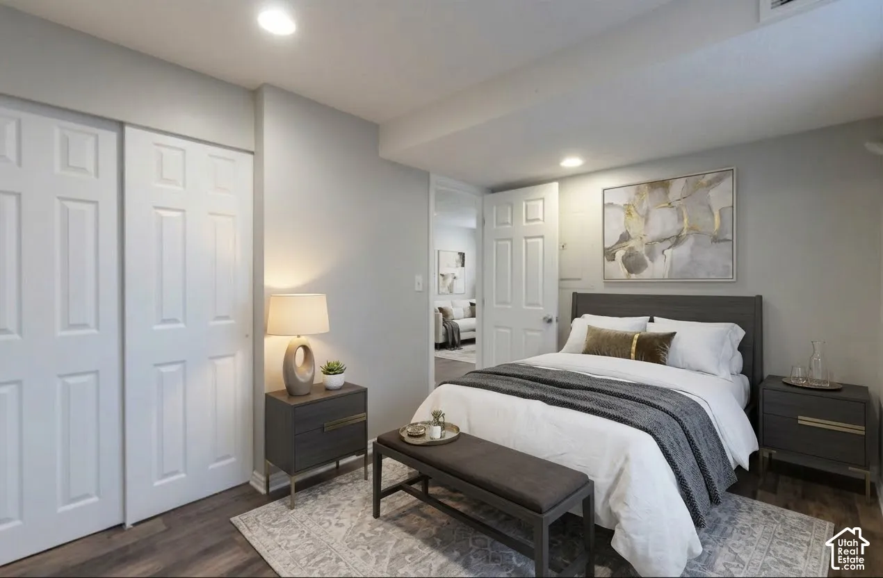 Neutral interior featuring wood-finish flooring, recessed lighting, and a double-door closet with six-panel doors