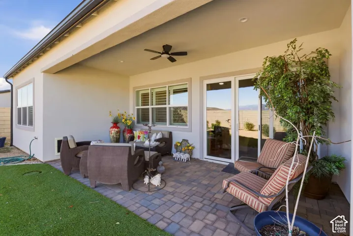 Covered patio featuring paver flooring, a ceiling fan, recessed lighting, and sliding glass doors