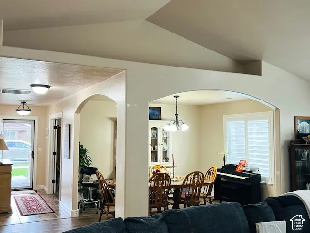Vaulted ceilings, arched wall openings, neutral interior paint, and window shutters