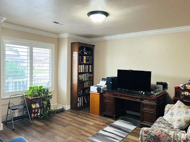 Wood-finish flooring, crown molding, built-in wooden shelving, and plantation shutters