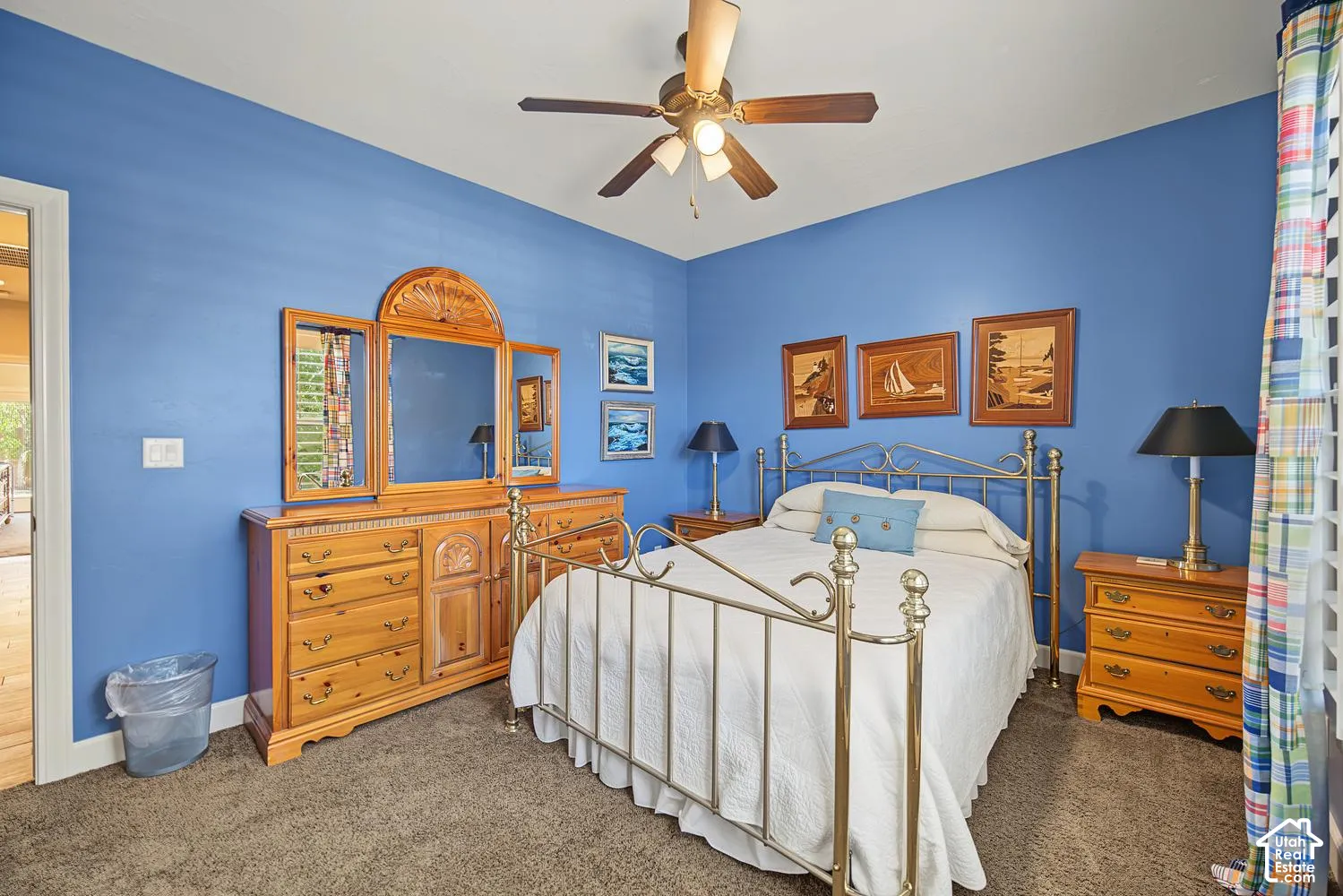 Bedroom featuring neutral carpet flooring and a multi-blade ceiling fan with integrated lighting