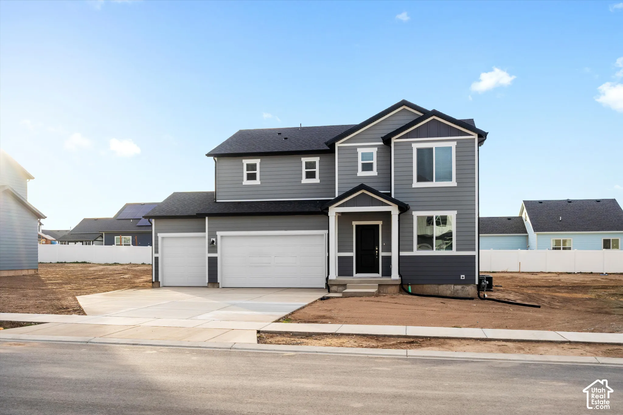 **DISCLAIMER** Elevation may vary. Two-story exterior featuring gray horizontal siding, an attached three-car garage, white trim accents, and a covered front entryway