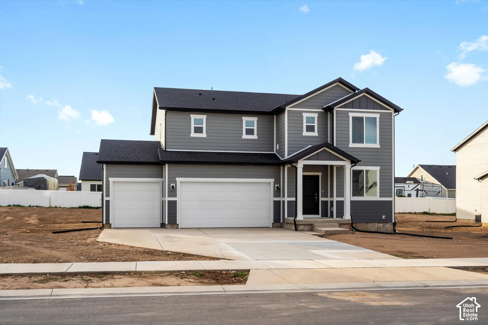 **DISCLAIMER** Elevation may vary. Two-story exterior featuring gray horizontal siding, white trim, a three-car garage, and a covered front porch entryway