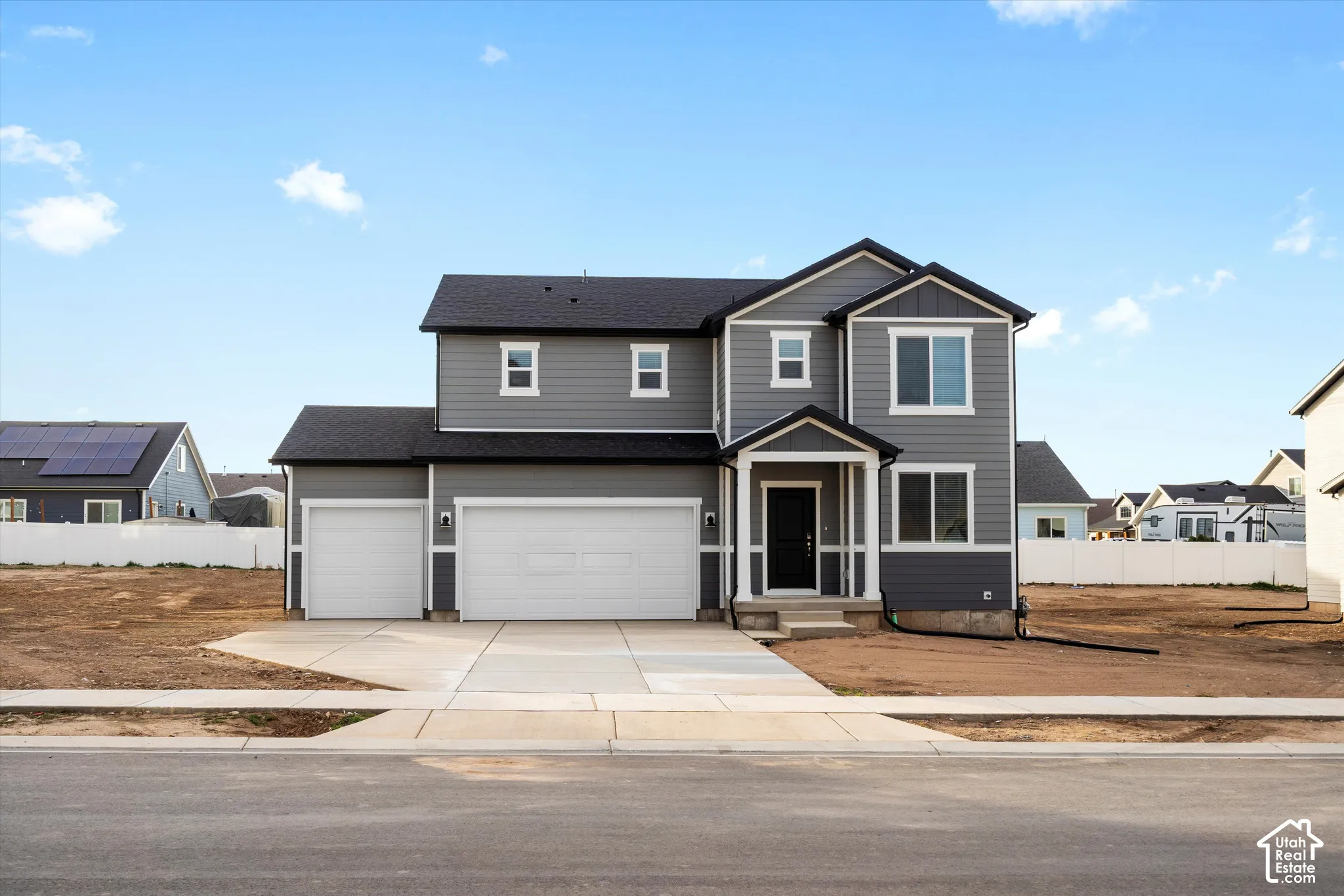 **DISCLAIMER** Elevation may vary. Two-story exterior featuring gray horizontal siding, dark shingle roofing, a three-car garage, and a covered front entryway with white columns