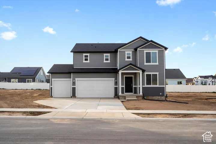 **DISCLAIMER** Elevation may vary. Two-story residence featuring horizontal lap siding, a three-car garage, a concrete driveway, and a covered front porch entry