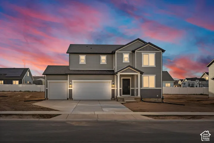 **DISCLAIMER** Elevation may vary. Two-story exterior with horizontal siding, covered entryway, attached three-car garage, and concrete driveway