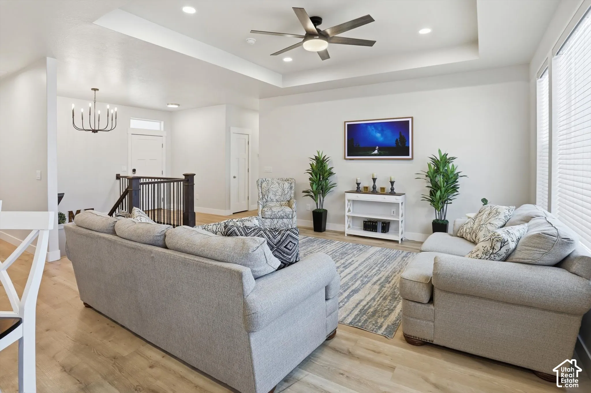 Tray ceiling featuring a contemporary ceiling fan, wood-finish flooring, recessed lighting.