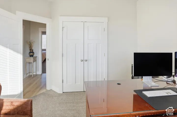 Neutral-toned interior featuring shaker-style double doors, crisp white millwork, and high-pile carpeting