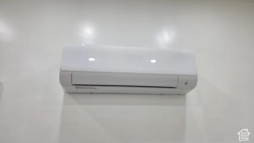 Wall-mounted ductless climate control unit featuring a white high-gloss finish