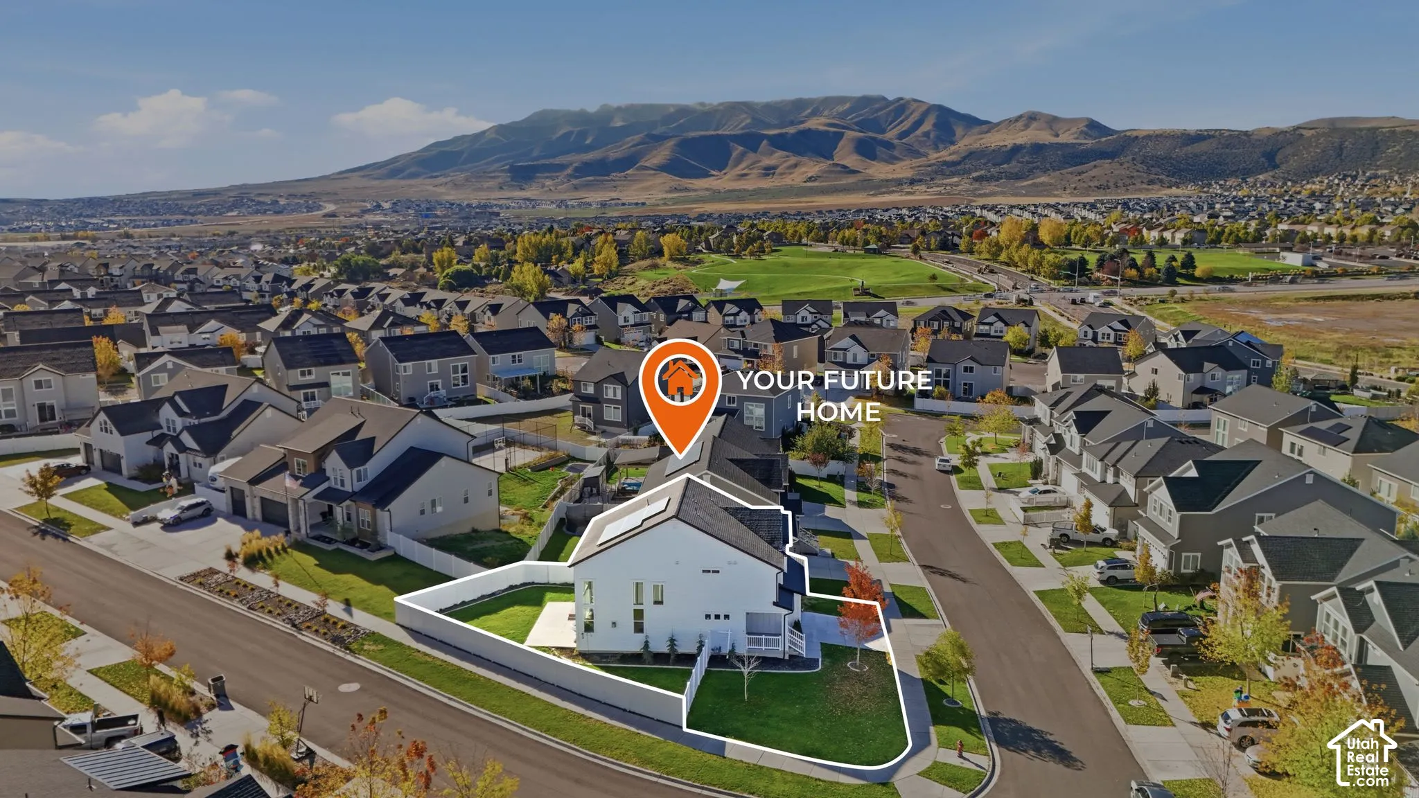 Corner lot property featuring a fully fenced backyard, manicured lawn, and mountain backdrop