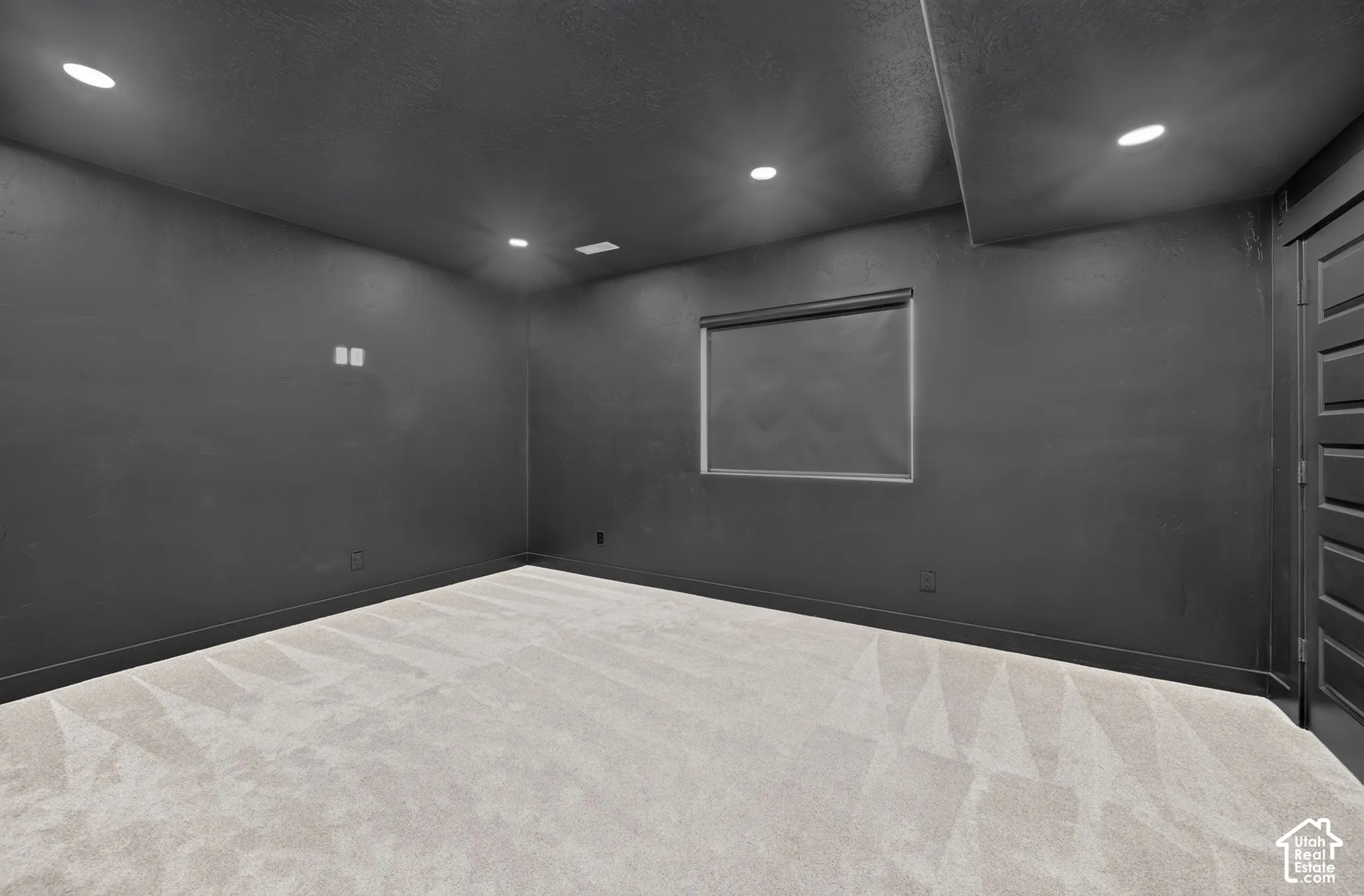Interior room featuring dark-painted walls, recessed ceiling lighting, wall-to-wall carpeting, and a multi-panel door