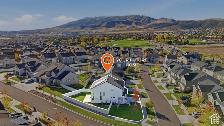 Corner lot property featuring a fully fenced backyard, manicured lawn, and mountain backdrop
