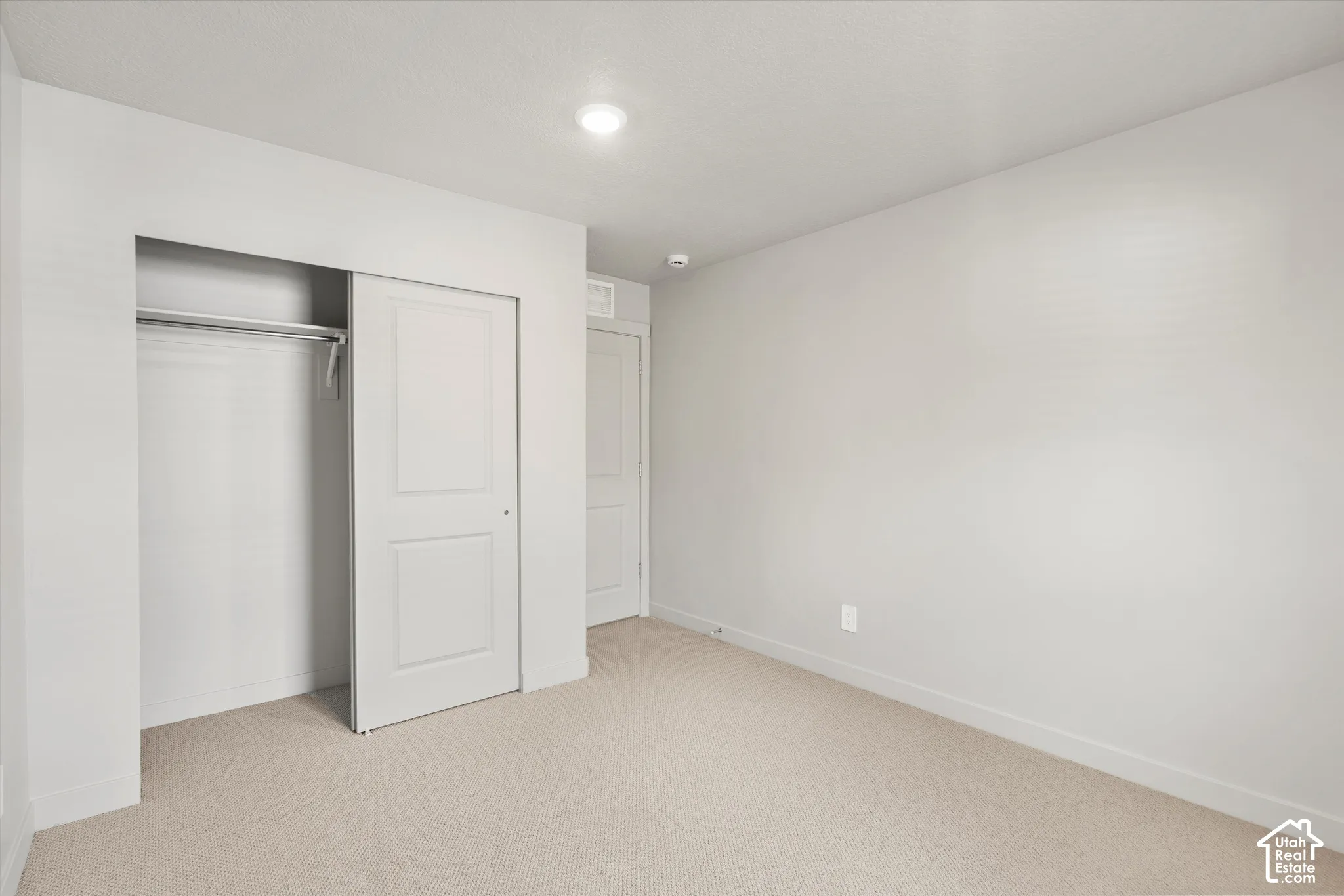 *DISCLAIMER* Interior color package may vary. Interior room featuring neutral-toned carpeting, recessed ceiling lighting, and a closet with a two-panel sliding door
