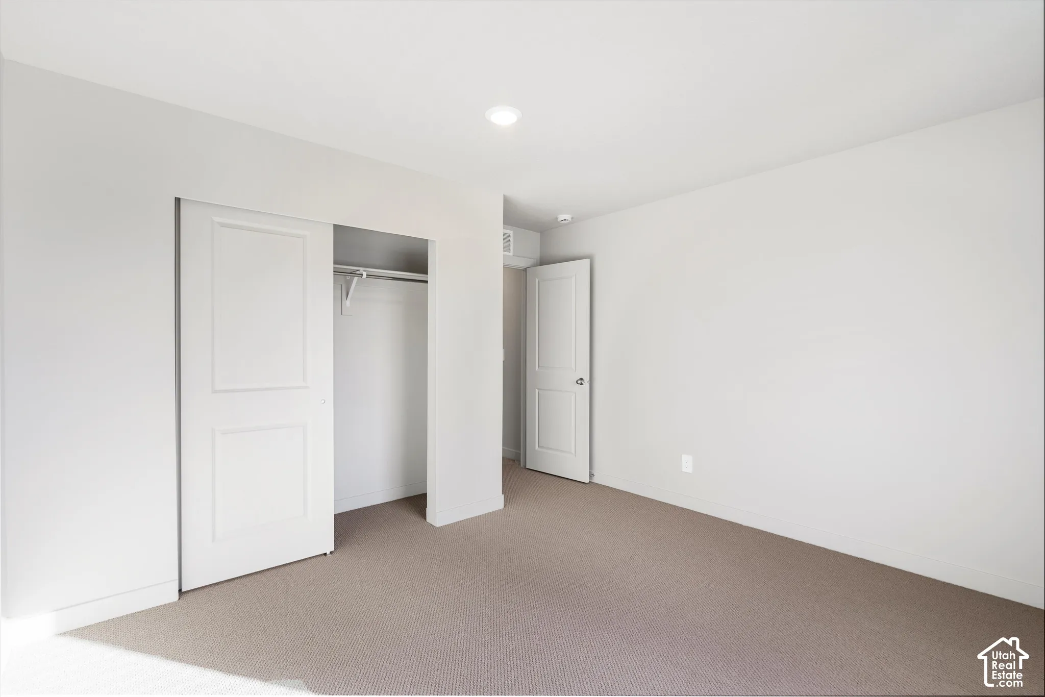 *DISCLAIMER* Interior color package may vary. Neutral-toned carpeted flooring, two-panel interior doors, recessed lighting, and a closet with a built-in hanging rod