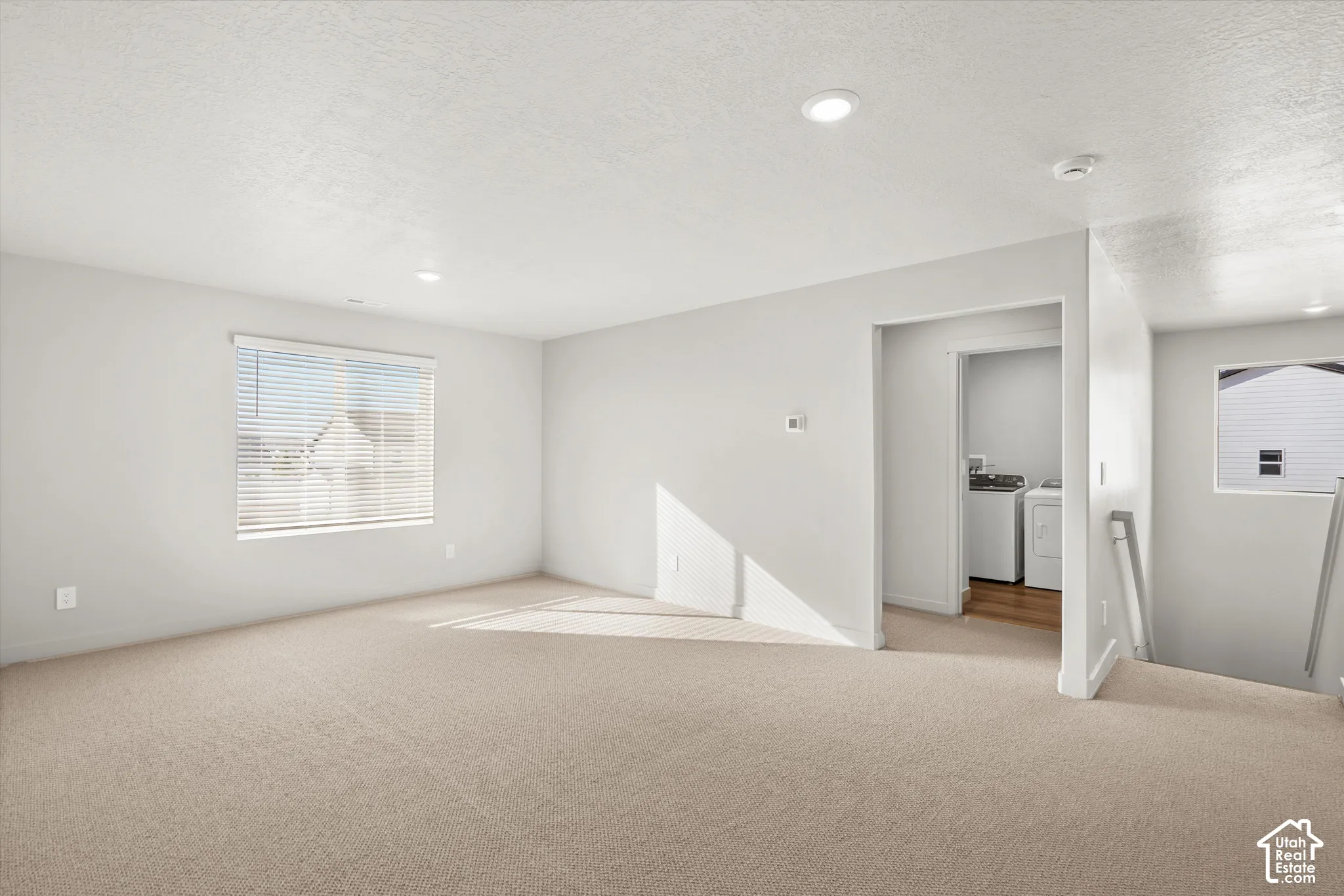 *DISCLAIMER* Interior color package may vary. Neutral interior space featuring recessed lighting, wall-to-wall carpeting, and a double-hung window with horizontal blinds