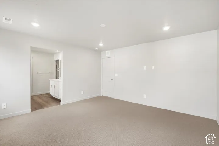 *DISCLAIMER* Interior color package may vary. Neutral carpeted flooring, recessed ceiling lighting, and a single-panel interior door