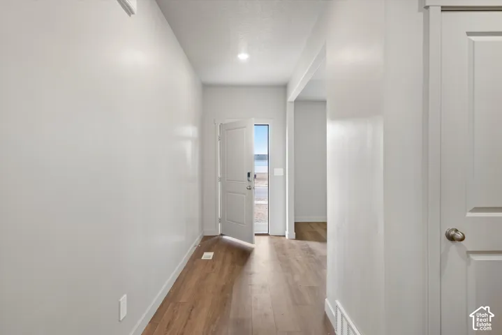 *DISCLAIMER* Interior color package may vary.  Entryway featuring wood-finish flooring, recessed lighting, and a paneled entry door