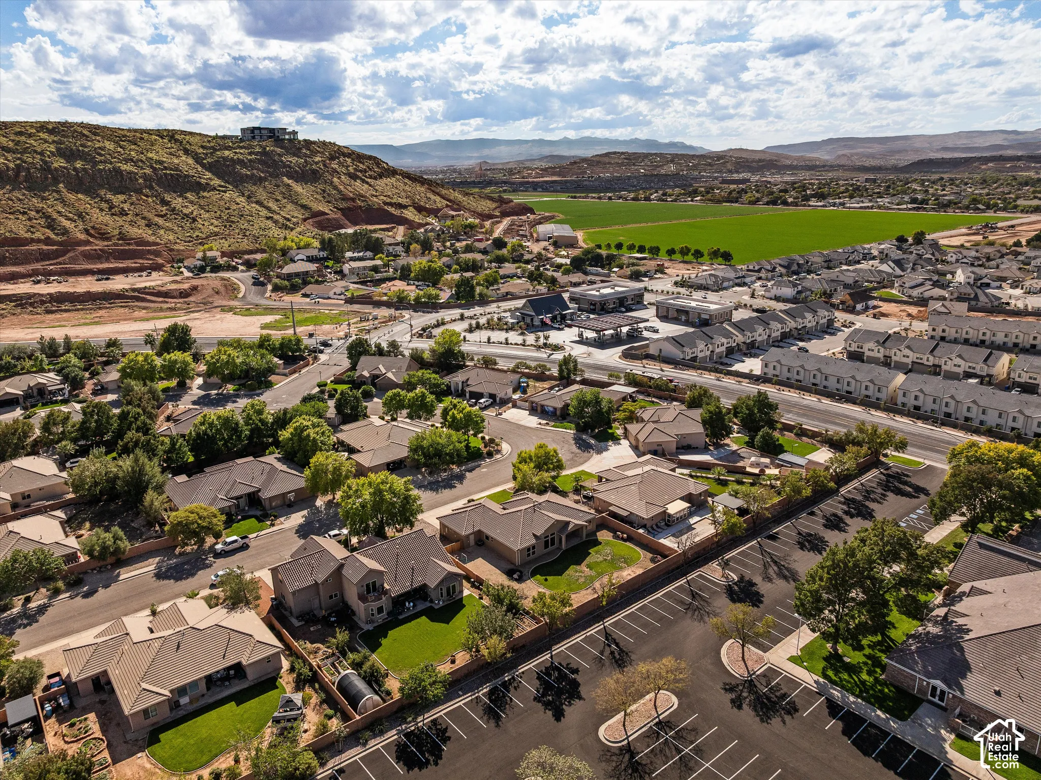 Aerial perspective showcasing surrounding desert terrain, mountain topography, and established suburban streetscape