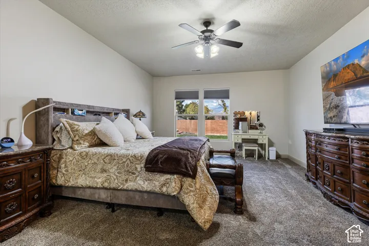 Spacious room featuring carpeting, dual-pane windows, and a ceiling fan with integrated lighting