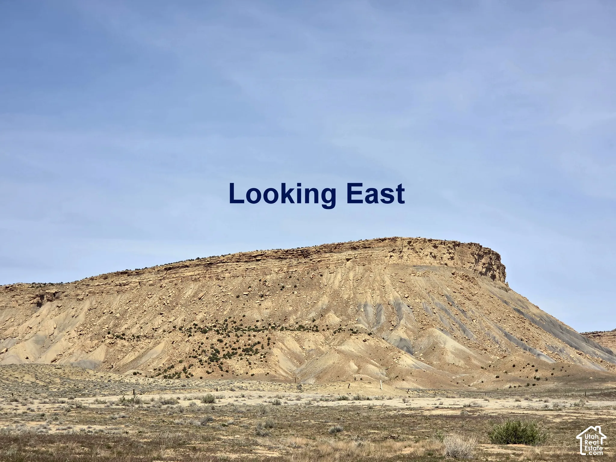 Prominent mesa landform featuring natural rock formations and desert landscape