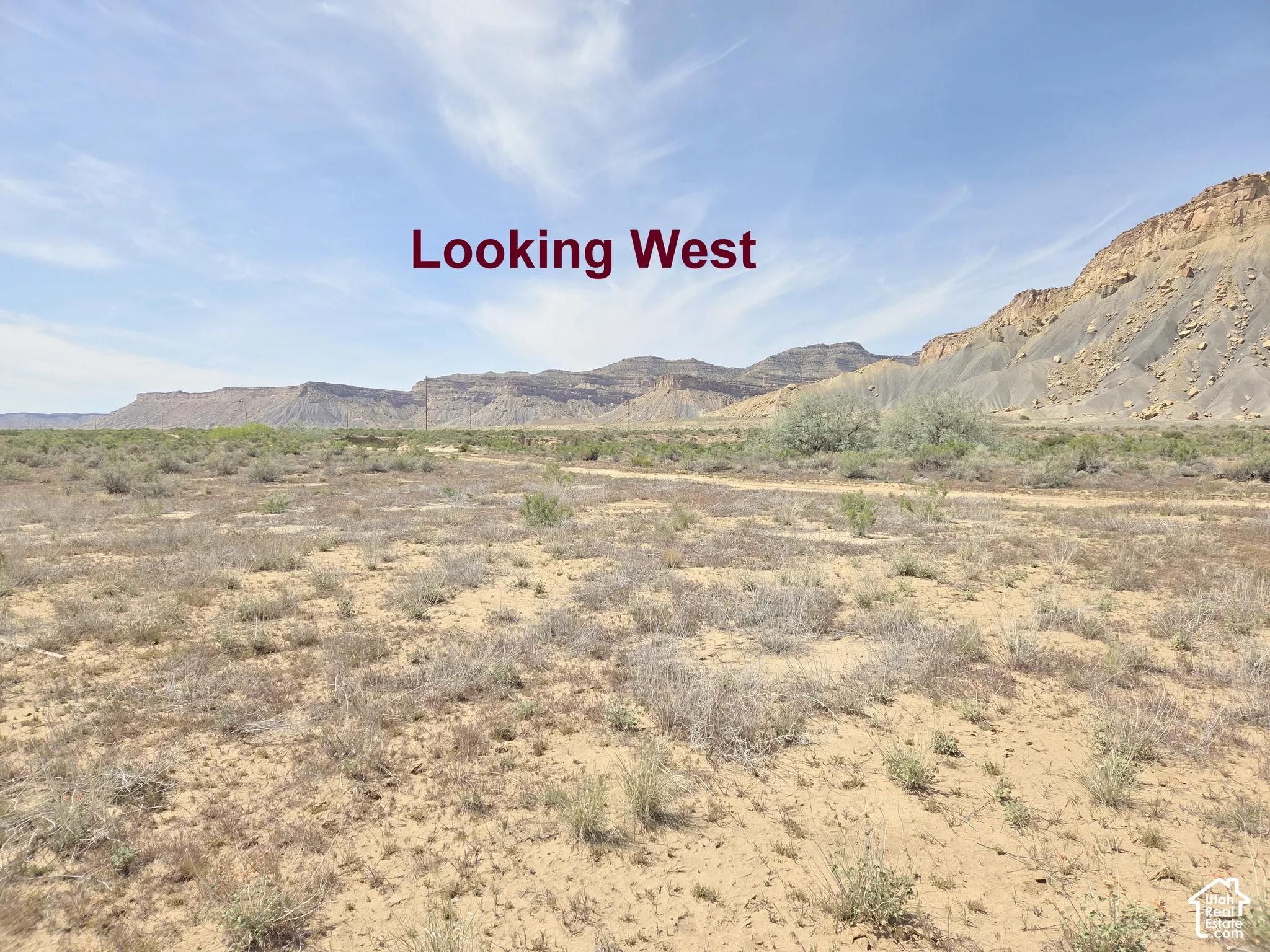 Expansive desert landscape featuring rugged rock formations and native vegetation