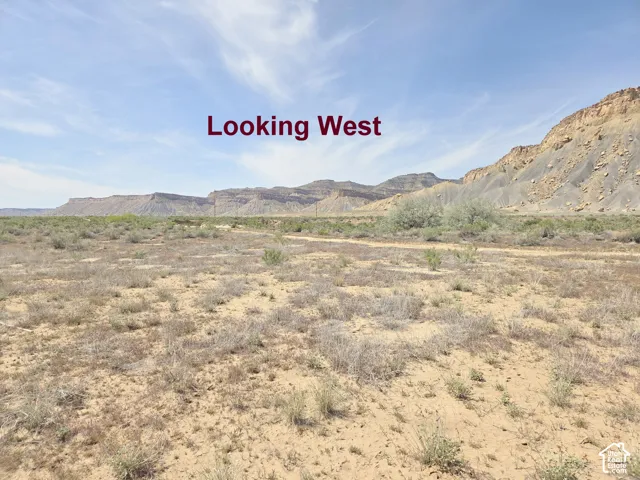 Expansive desert landscape featuring rugged rock formations and native vegetation