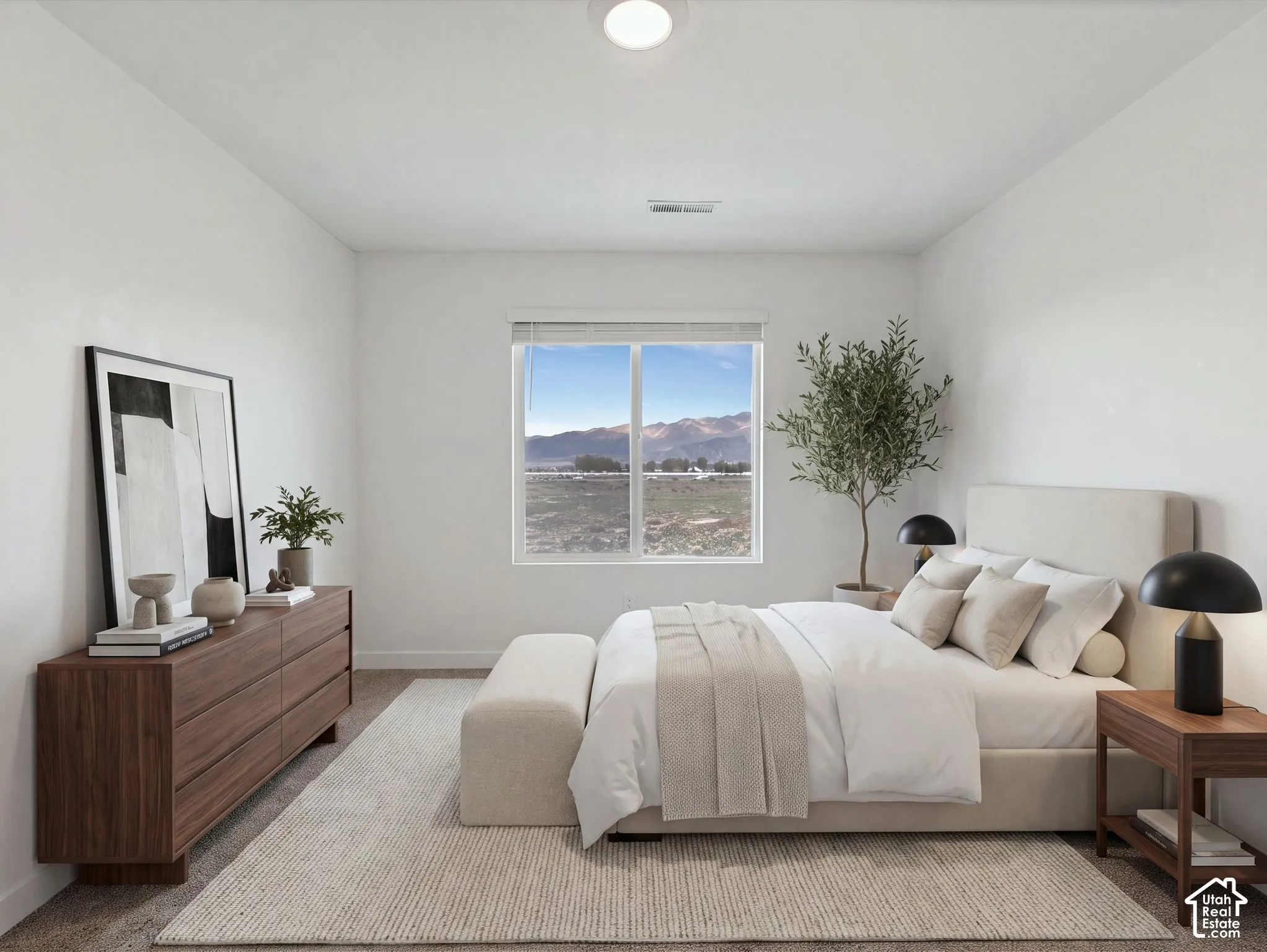 Neutral-toned room featuring a wide sliding window, mountain backdrop, and ceiling-mounted flush light fixture