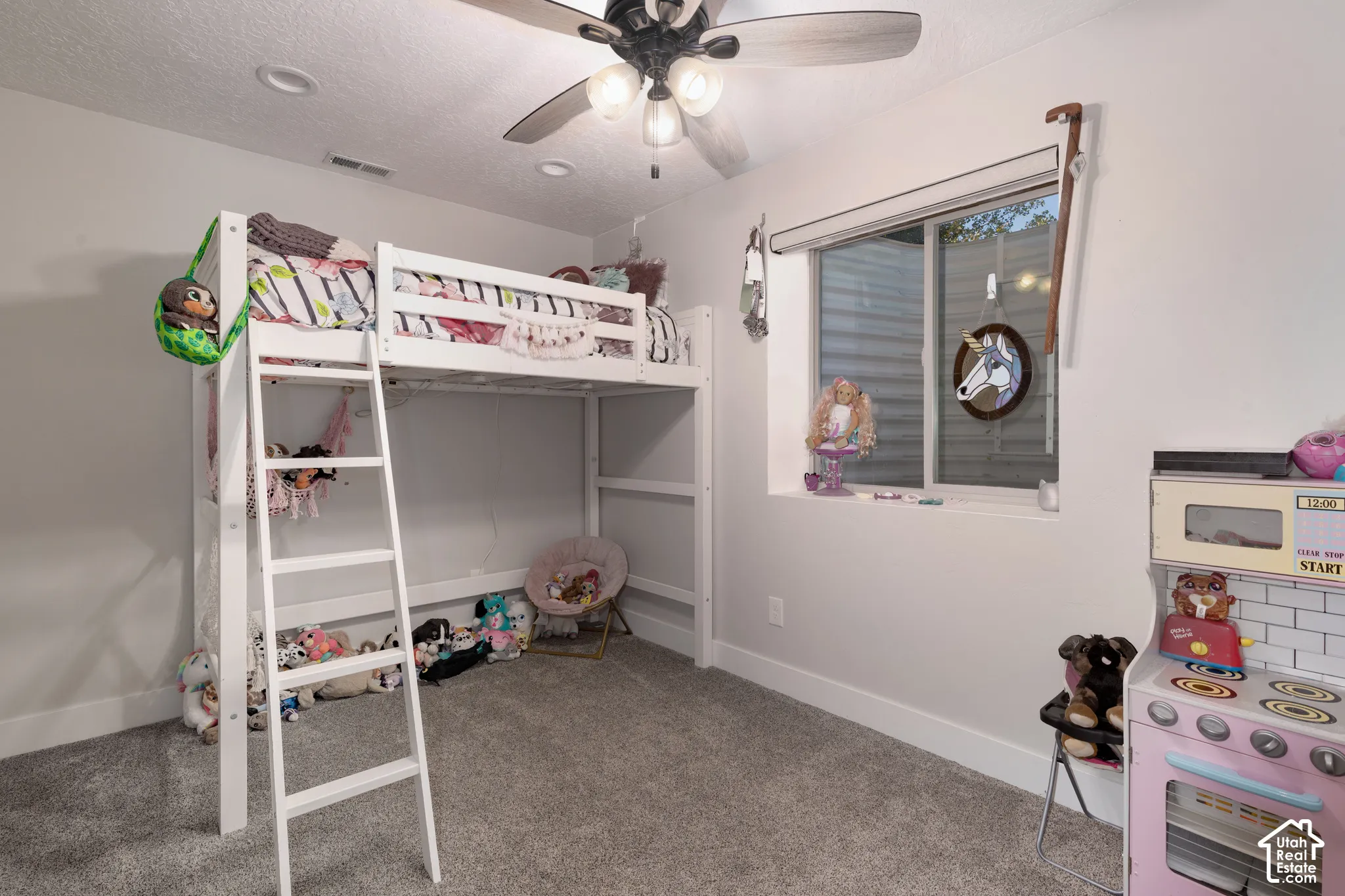 Neutral-toned bedroom featuring recessed lighting, a multi-light ceiling fan, and carpeted flooring