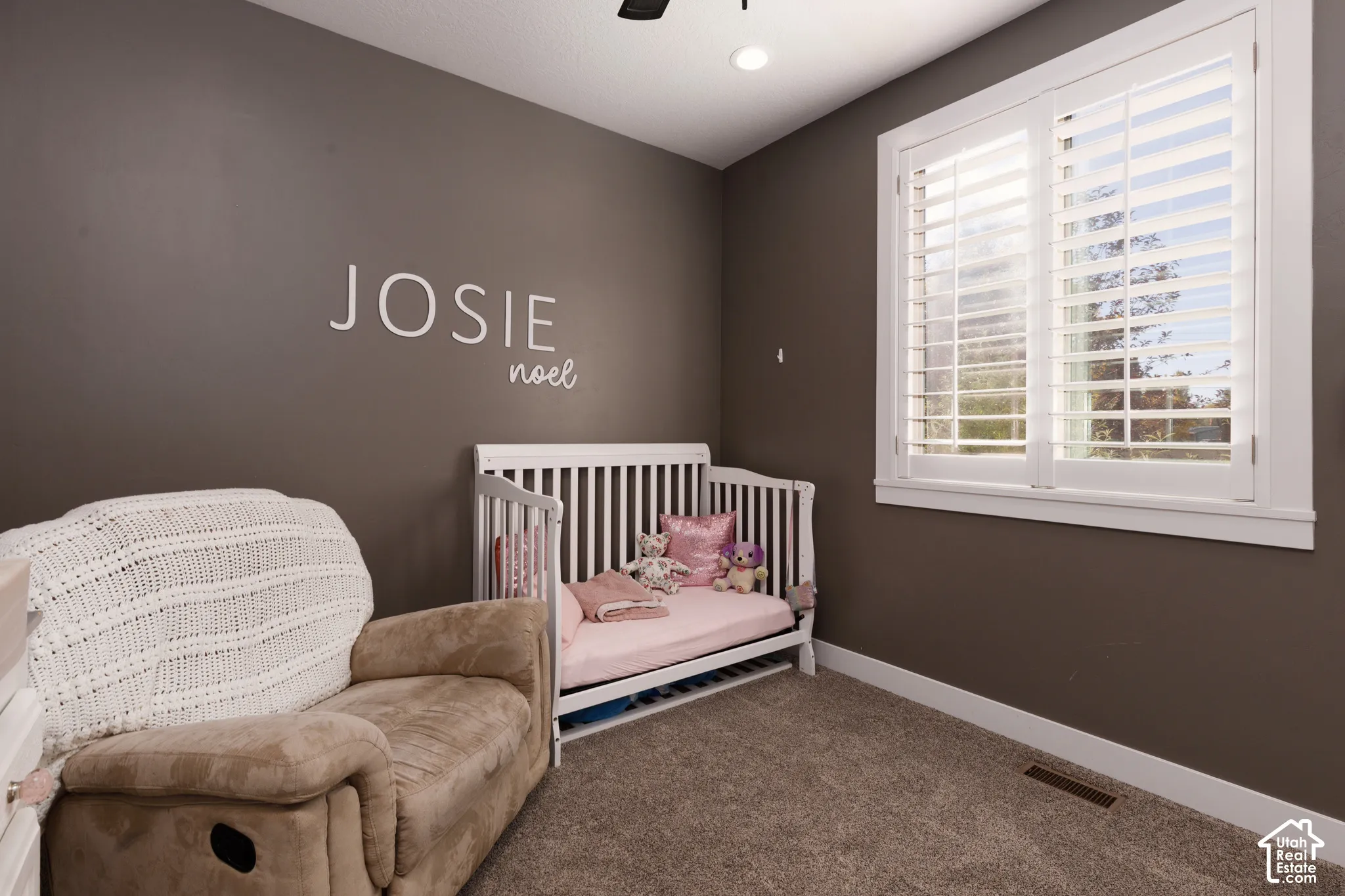 Room featuring neutral wall tones, plantation shutters, and recessed lighting