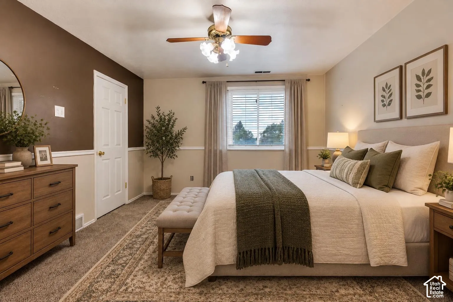 Carpeted room with two-toned wall paint, chair rail molding, multi-light ceiling fan, and window with blinds
