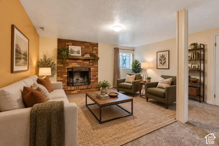 Brick masonry fireplace with a wooden mantel and metal insert, complemented by neutral carpeting