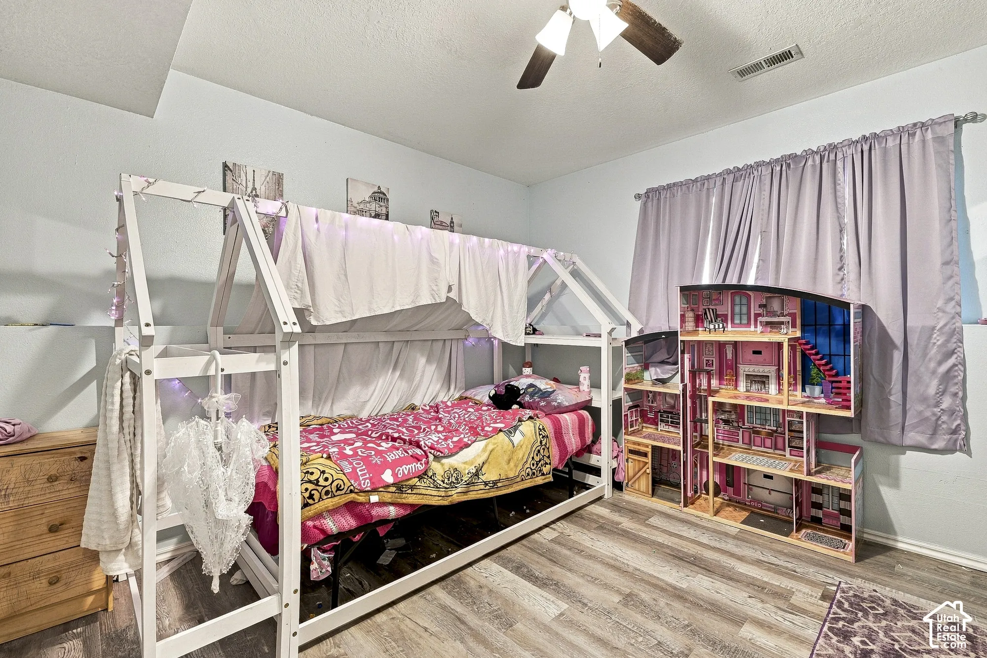 Wood-finish flooring and a central ceiling fan with integrated lighting