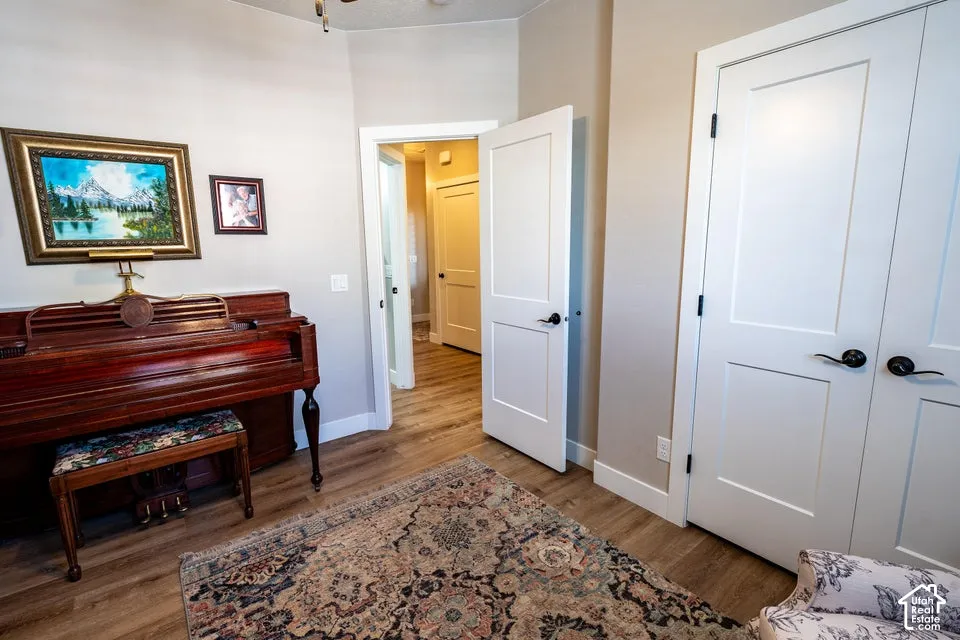 Wood-finish flooring, two-panel shaker-style interior doors, and matte black door hardware
