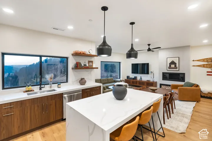 Kitchen featuring a waterfall-edge island with solid-surface countertop