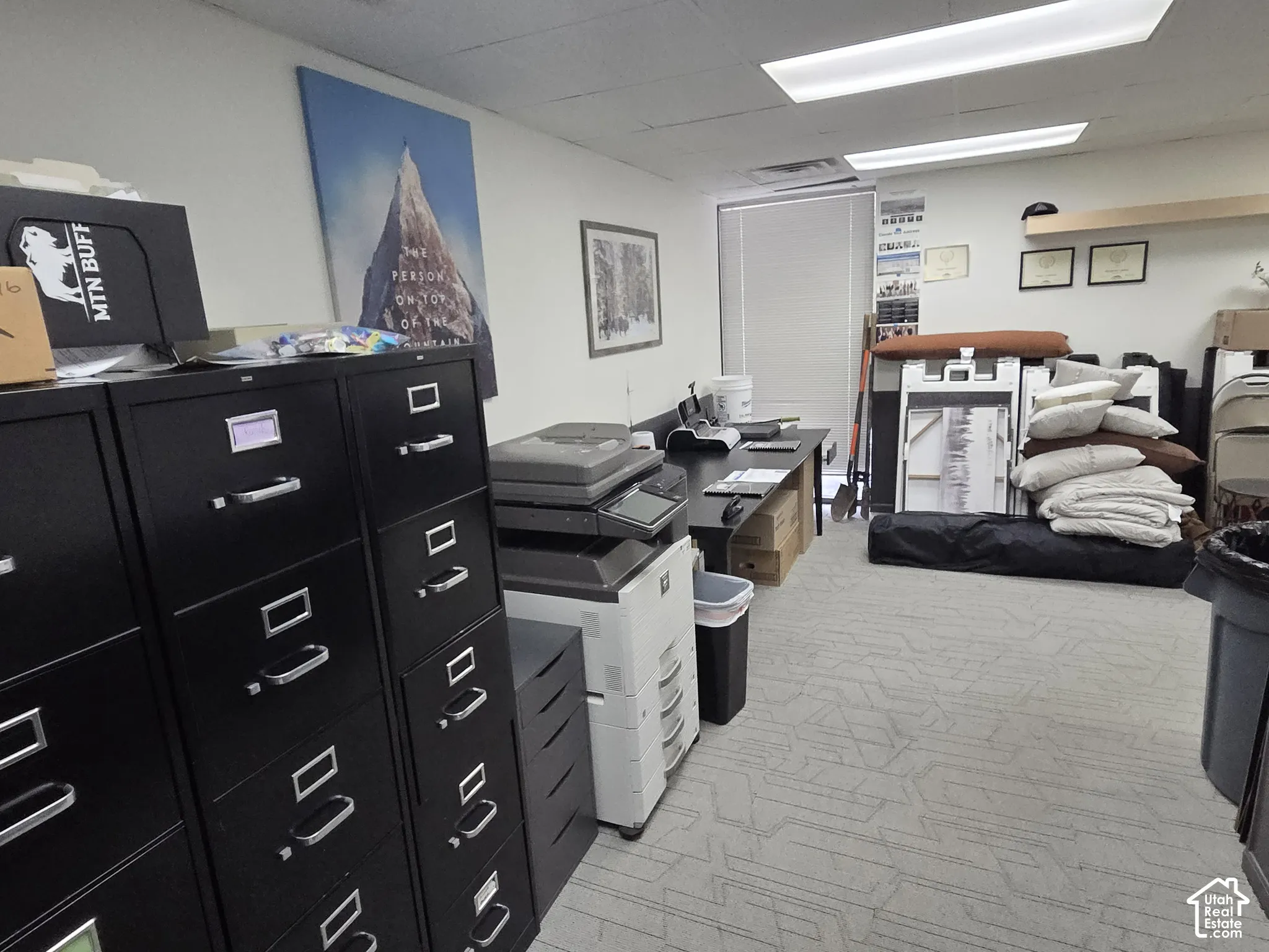 Room featuring patterned carpeted flooring, recessed lighting, and a window with horizontal blinds