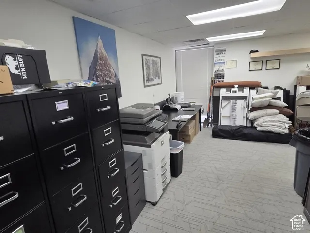 Room featuring patterned carpeted flooring, recessed lighting, and a window with horizontal blinds