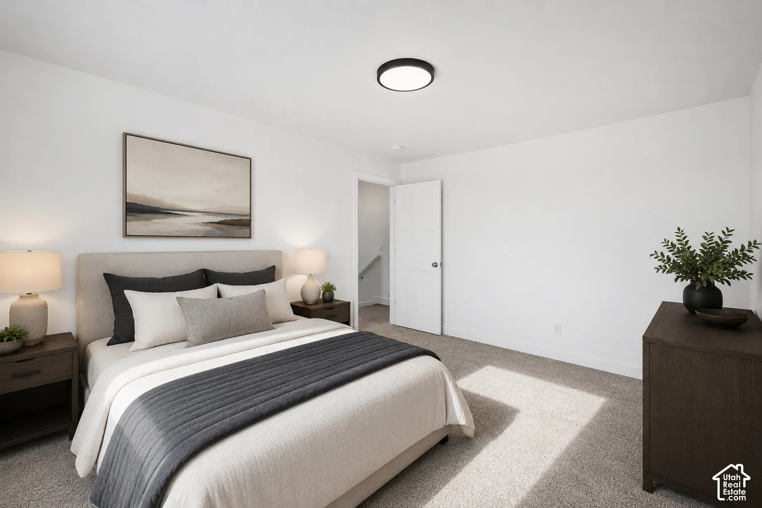 Neutral interior room featuring neutral-tone carpeting, minimalist flush-mount lighting, and a solid-core interior door