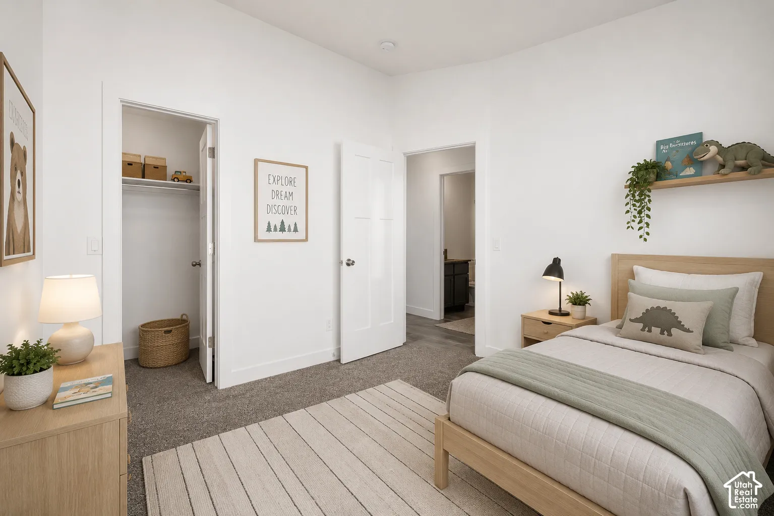 Room featuring wall-to-wall carpeting, neutral paint, a walk-in closet with built-in shelving, and two-panel interior doors