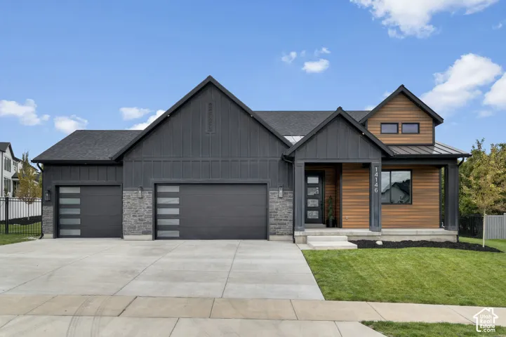 Modern exterior featuring vertical board-and-batten siding, stacked stone accents, horizontal wood-finish cladding, and two multi-panel garage doors with frosted glass inserts